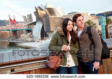 Young couple visiting the city, Guggenheim Museum, Abandoibarra, Bilbao, Bizkaia, Basque Country, Spain View Large Photo Image Stock Photograph - Young couple visiting the city, Guggenheim Museum, Abandoibarra, Bilbao, Bizkaia, Basque Country, Spain. Fotosearch