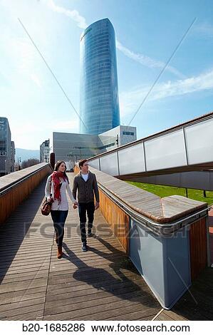Young couple walking, Iberdrola Tower, Padre Arrupe Bridge, Abandoibarra, Bilbao, Bizkaia, Basque Country, Spain View Large Photo Image Stock Photograph - Young couple walking, Iberdrola Tower, Padre Arrupe Bridge, Abandoibarra, Bilbao, Bizkaia, Basque Country, Spain. Fotosearch