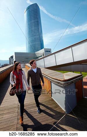 Young couple walking, Iberdrola Tower, Padre Arrupe Bridge, Abandoibarra, Bilbao, Bizkaia, Basque Country, Spain View Large Photo Image Stock Photography - Young couple walking, Iberdrola Tower, Padre Arrupe Bridge, Abandoibarra, Bilbao, Bizkaia, Basque Country, Spain. Fotosearch