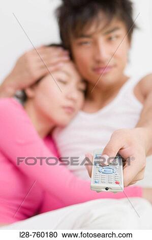 Young Couple watching movie on tv. View Large Photo Image Stock Image - Young Couple watching movie on tv.. Fotosearch