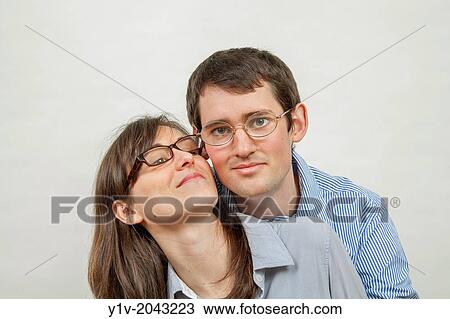 Stock Image - Young couple wearing glasses.. Fotosearch