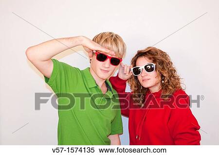 Stock Photography - Young couple wearing sunglasses. Fotosearch