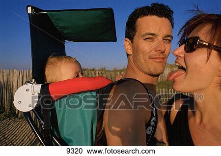 Young couple with baby having fun View Large Photo Image Stock Image - Young couple with baby having fun. Fotosearch