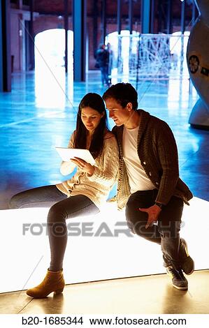 Young couple with digital tablet, digital tablet, Alhondiga building, leisure and culture center, Bilbao, Bizkaia, Basque Country, Spain View Large Photo Image Picture - Young couple with digital tablet, digital tablet, Alhondiga building, leisure and culture center, Bilbao, Bizkaia, Basque Country, Spain. Fotosearch