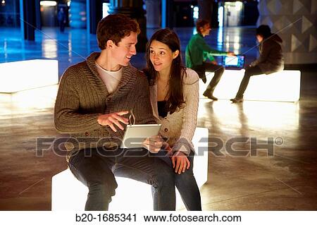 Young couple with digital tablet, digital tablet, Alhondiga building, leisure and culture center, Bilbao, Bizkaia, Basque Country, Spain View Large Photo Image Stock Image - Young couple with digital tablet, digital tablet, Alhondiga building, leisure and culture center, Bilbao, Bizkaia, Basque Country, Spain. Fotosearch