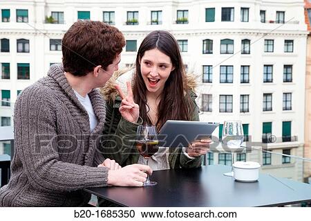 Young couple with digital tablet, digital tablet, Urban terrace bar, Alhondiga building, leisure and culture center, Bilbao, Bizkaia, Basque Country, Spain View Large Photo Image Stock Image - Young couple with digital tablet, digital tablet, Urban terrace bar, Alhondiga building, leisure and culture center, Bilbao, Bizkaia, Basque Country, Spain. Fotosearch