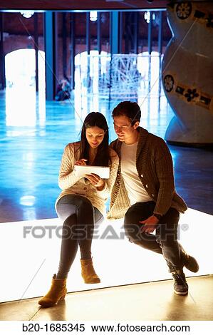 Young couple with digital tablet, digital tablet, Alhondiga building, leisure and culture center, Bilbao, Bizkaia, Basque Country, Spain View Large Photo Image Stock Photography - Young couple with digital tablet, digital tablet, Alhondiga building, leisure and culture center, Bilbao, Bizkaia, Basque Country, Spain. Fotosearch