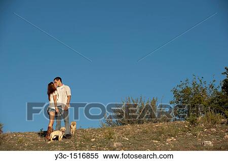 Stock Photography - Young couple with dogs. Fotosearch