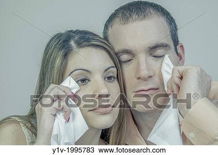 Stock Image - Young couple with tissues.. Fotosearch