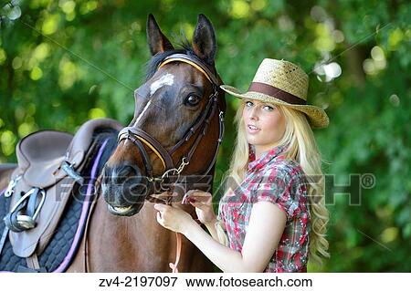 Young cowgirl standing beside a polish arabian horse. View Large Photo Image Stock Photo - Young cowgirl standing beside a polish arabian horse.. Fotosearch