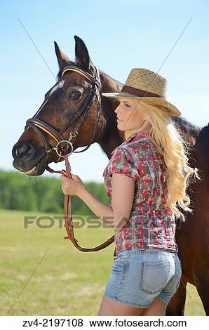 Young cowgirl standing beside a polish arabian horse. View Large Photo Image Stock Photo - Young cowgirl standing beside a polish arabian horse.. Fotosearch