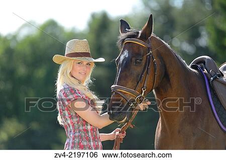 Young cowgirl standing beside a polish arabian horse. View Large Photo Image Stock Photograph - Young cowgirl standing beside a polish arabian horse.. Fotosearch
