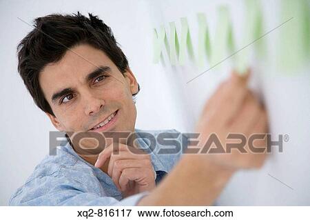 Young creative choosing notepapers View Large Photo Image Stock Photo - Young creative choosing notepapers. Fotosearch