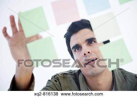Stock Photo - Young creative working with ideas. Fotosearch