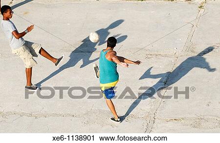 Young Cubans play football in a park, in Havana, Cuba View Large Photo Image Stock Image - Young Cubans play football in a park, in Havana, Cuba. Fotosearch