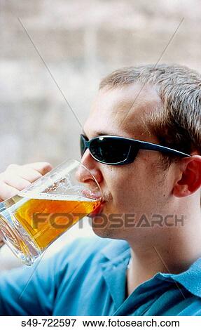 Stock Photo - Young drinking beer.. Fotosearch