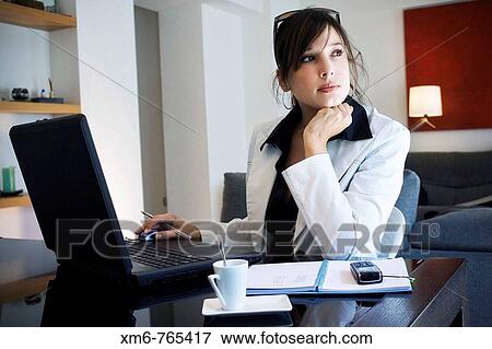 Young executive meditating while working on her laptop View Large Photo Image Stock Photo - Young executive meditating while working on her laptop. Fotosearch