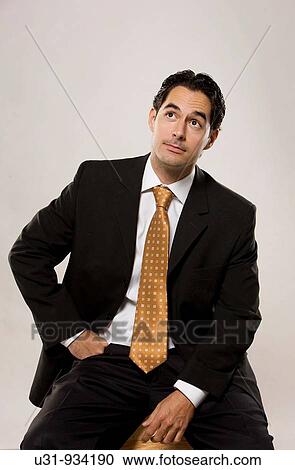 Young executive thinking looking up View Large Photo Image Stock Image - Young executive thinking looking up. Fotosearch