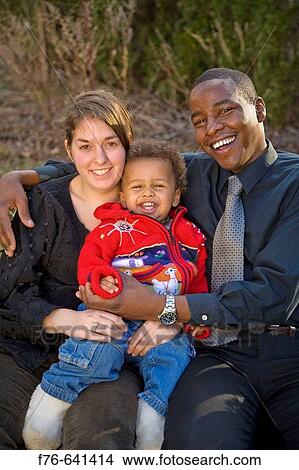 Young family. Caucasian mother and African (Kenyan) father with their 18 month old son View Large Photo Image Picture - Young family. Caucasian mother and African (Kenyan) father with their 18 month old son. Fotosearch
