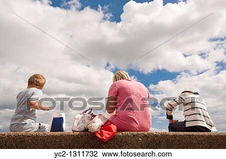 Young family eat their fish and chips on the beach at Aldeburgh, Suffolk, England, Great Britain, Uk View Large Photo Image Stock Image - Young family eat their fish and chips on the beach at Aldeburgh, Suffolk, England, Great Britain, Uk. Fotosearch