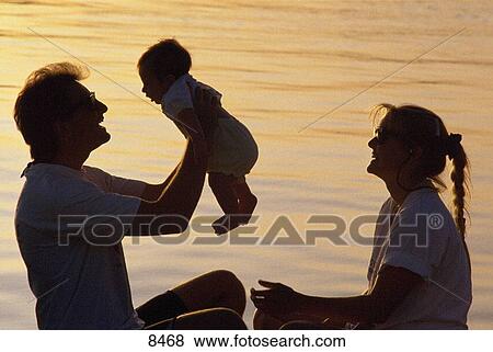 Young family enjoying their time together View Large Photo Image Stock Photo - Young family enjoying their time together. Fotosearch