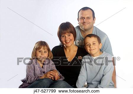 young family of four, sitting together smiling into camera View Large Photo Image Stock Photo - young family of four, sitting together smiling into camera. Fotosearch