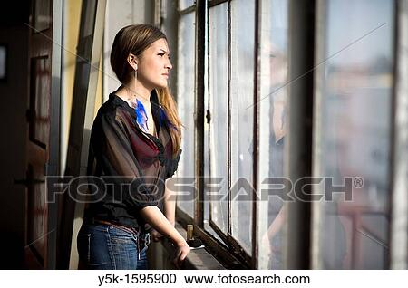 Young, fashionable woman from Afghanistan, living in asylum in the Netherlands, posing near the docks of Rotterdam harbor, leaning against the window of an old, abandoned industrial building. View Large Photo Image Stock Image - Young, fashionable woman from Afghanistan, living in asylum in the Netherlands, posing near the docks of Rotterdam harbor, leaning against the window of an old, abandoned industrial building.. Fotosearch
