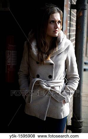 Young, fashionable woman from Afghanistan, living in asylum in the Netherlands, posing near the docks of Rotterdam harbor, wearing a winter-coat. View Large Photo Image Stock Photo - Young, fashionable woman from Afghanistan, living in asylum in the Netherlands, posing near the docks of Rotterdam harbor, wearing a winter-coat.. Fotosearch