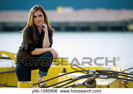 Young, fashionable woman from Afghanistan, living in asylum in the Netherlands, posing near the docks of Rotterdam harbor, leaning on crane-parts. View Large Photo Image Stock Photograph - Young, fashionable woman from Afghanistan, living in asylum in the Netherlands, posing near the docks of Rotterdam harbor, leaning on crane-parts.. Fotosearch