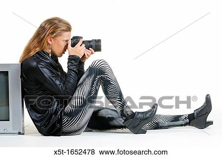 Stock Photo - young Fashionable woman with camera. Fotosearch