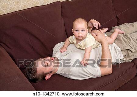 Young father with his six-month old son View Large Photo Image Stock Image - Young father with his six-month old son. Fotosearch