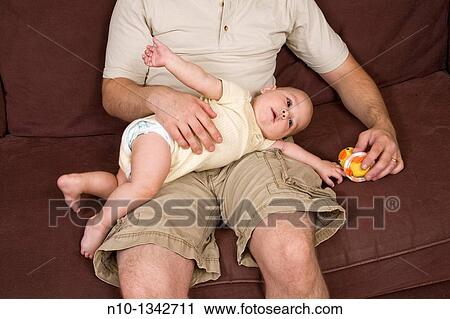 Young father with his six-month old son View Large Photo Image Stock Image - Young father with his six-month old son. Fotosearch