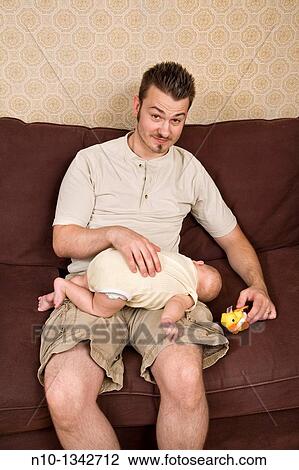 Stock Image - Young father with his six-month old son. Fotosearch