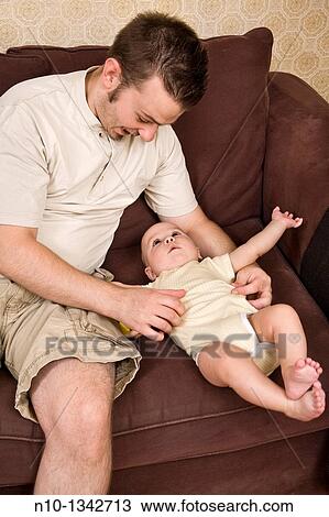 Young father with his six-month old son View Large Photo Image Stock Image - Young father with his six-month old son. Fotosearch