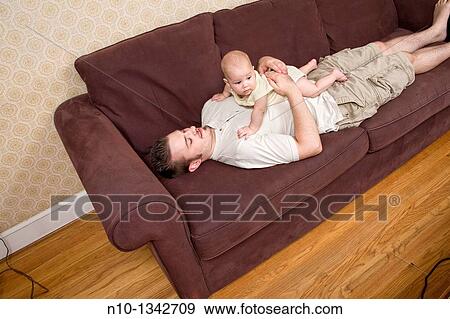 Young father with his six-month old son View Large Photo Image Stock Photo - Young father with his six-month old son. Fotosearch