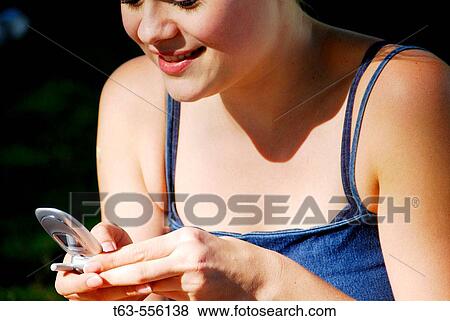 young female adult using cell phone View Large Photo Image Stock Photo - young female adult using cell phone. Fotosearch