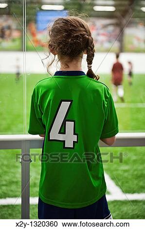 Young female athlete watches a soccer game in progress View Large Photo Image Stock Image - Young female athlete watches a soccer game in progress. Fotosearch