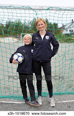 Stock Image - young female football players, Rebecca and her mother, Tromso County of Troms, Norway, Northern Europe. Fotosearch