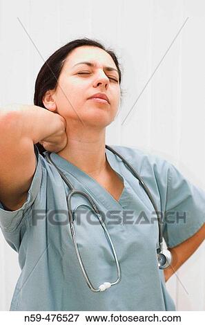 Young female medical professional looking tired and stressed. View Large Photo Image Stock Photo - Young female medical professional looking tired and stressed.. Fotosearch