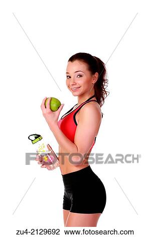Young female model with apple anf flask. View Large Photo Image Stock Image - Young female model with apple anf flask.. Fotosearch