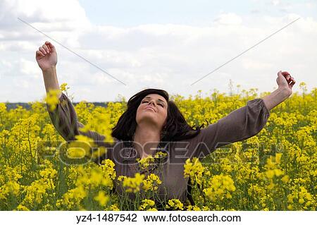 Young female playing in a canola field, Washinton state View Large Photo Image Stock Image - Young female playing in a canola field, Washinton state. Fotosearch
