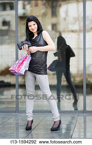 Young female shopper View Large Photo Image Stock Image - Young female shopper. Fotosearch