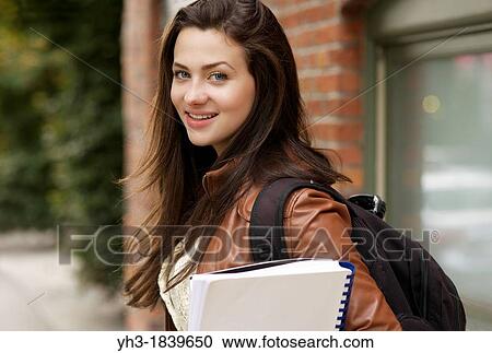 Young female student smiling in front of the camera View Large Photo Image Stock Image - Young female student smiling in front of the camera. Fotosearch
