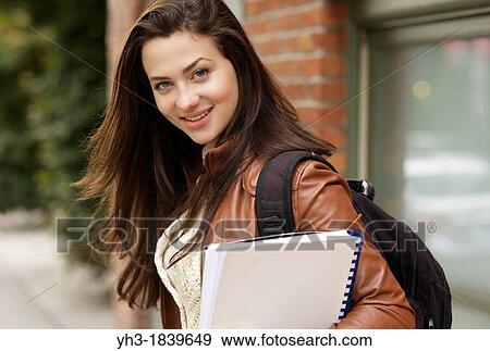Young female student smiling in front of the camera View Large Photo Image Stock Photo - Young female student smiling in front of the camera. Fotosearch