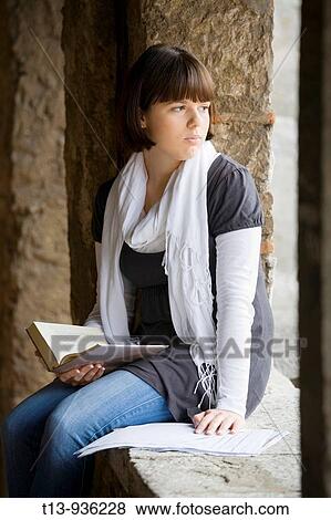 Young female student with a book and papers View Large Photo Image Stock Photo - Young female student with a book and papers. Fotosearch