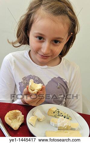 Young french girl (8) having cheese at lunch View Large Photo Image Stock Photo - Young french girl (8) having cheese at lunch. Fotosearch