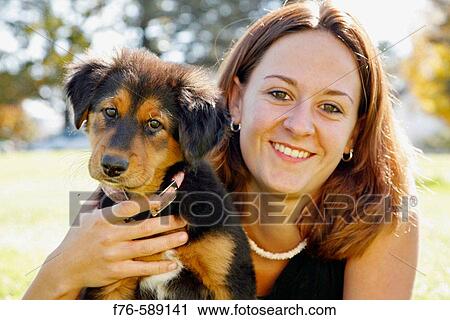 Young girl (18 yrs old) with 10 week old mixed breed puppy View Large Photo Image Stock Image - Young girl (18 yrs old) with 10 week old mixed breed puppy. Fotosearch