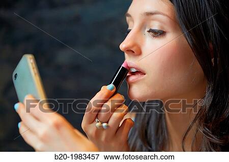 Young Girl 24 years. Applying lipstick View Large Photo Image Stock Photo - Young Girl 24 years. Applying lipstick. Fotosearch
