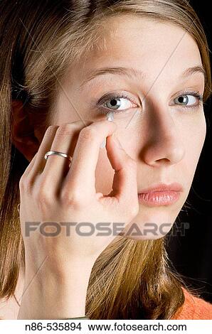 Young girl applying eyeliner View Large Photo Image Picture - Young girl applying eyeliner. Fotosearch