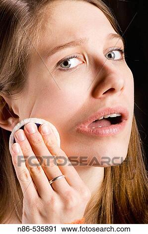 Stock Image - Young girl applying make-up. Fotosearch